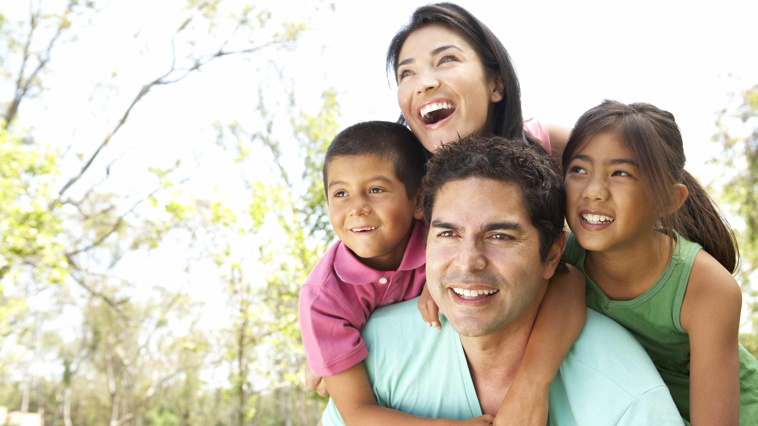 Father and mother with a boy and girl hugging and smiling