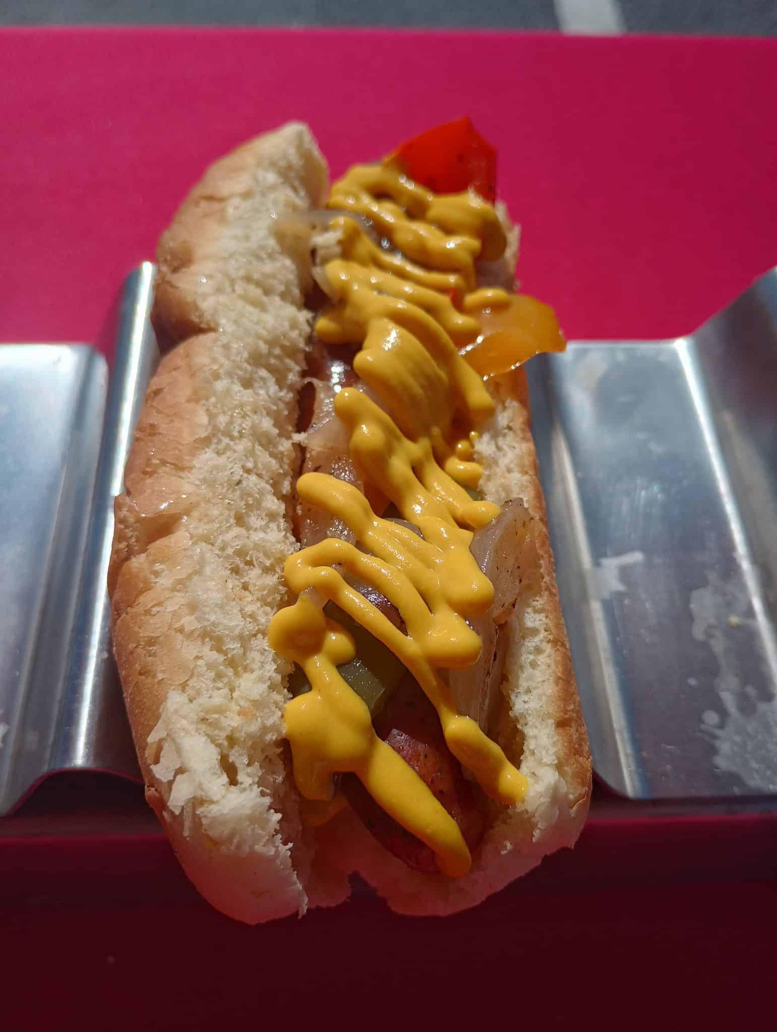 Mustard bell peppers and onions on a hot dog