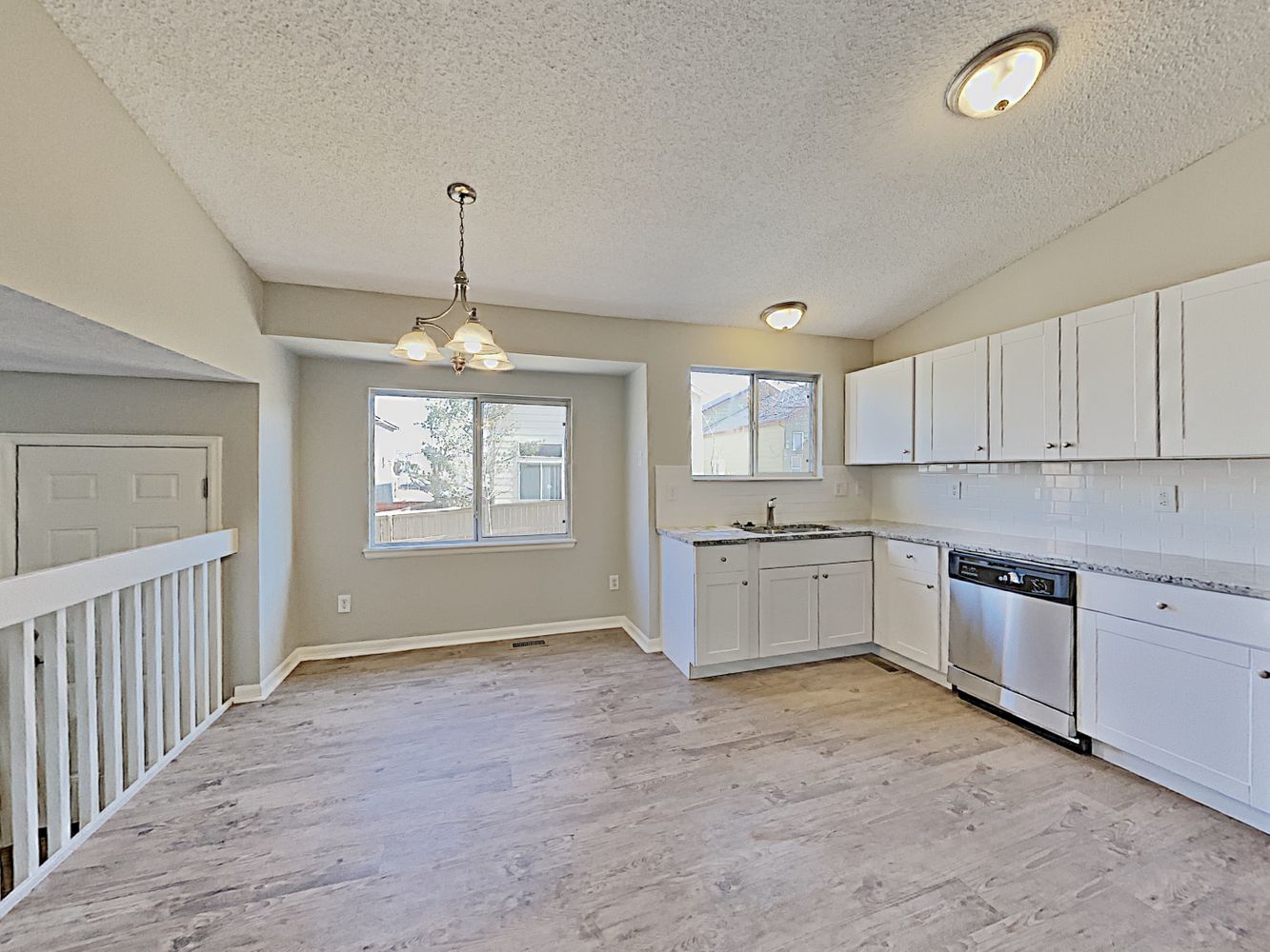 Kitchen with granite countertops and stainless-steel appliances at Invitation Homes Denver.