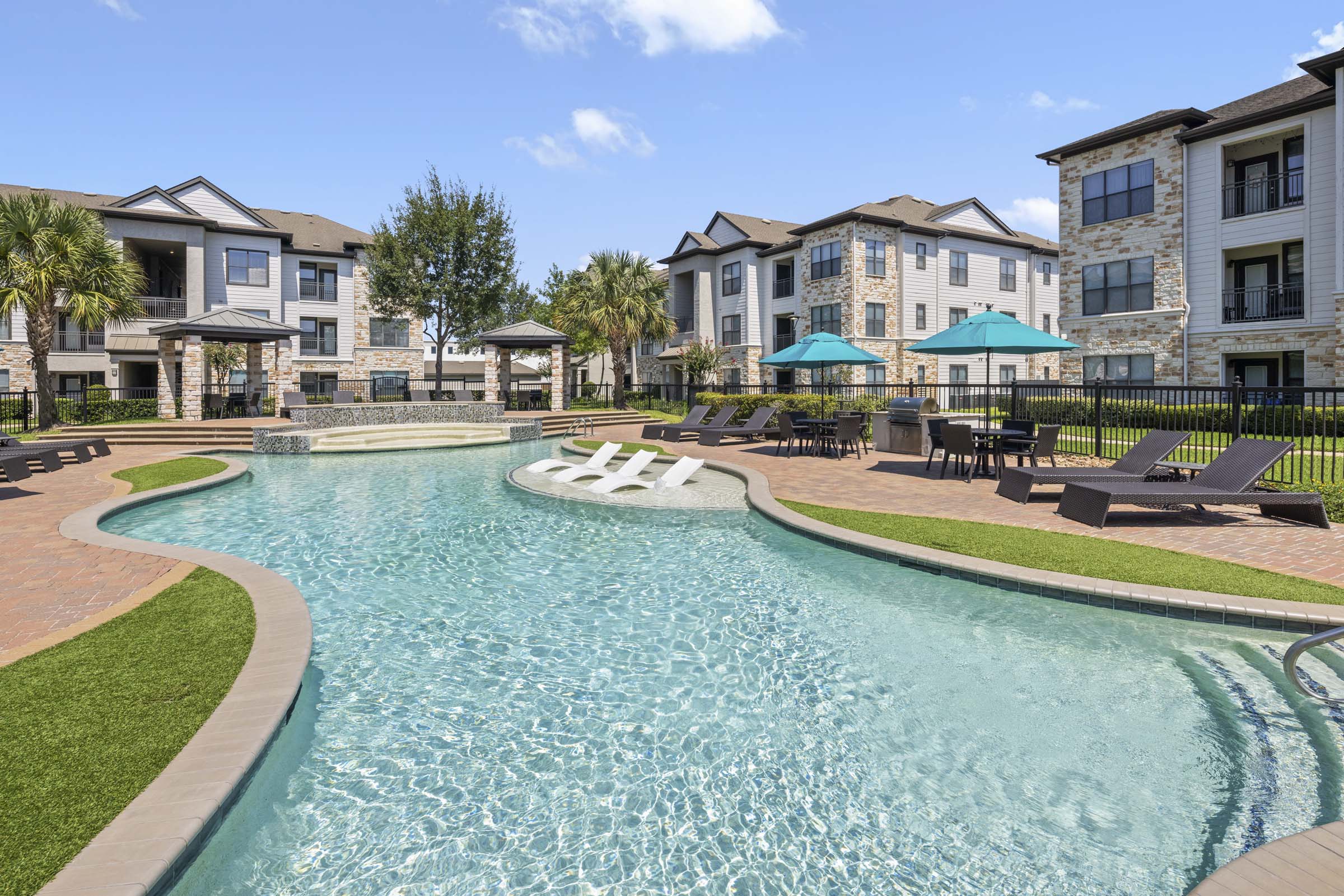 Resort style pool with grilling areas and tanning shelf