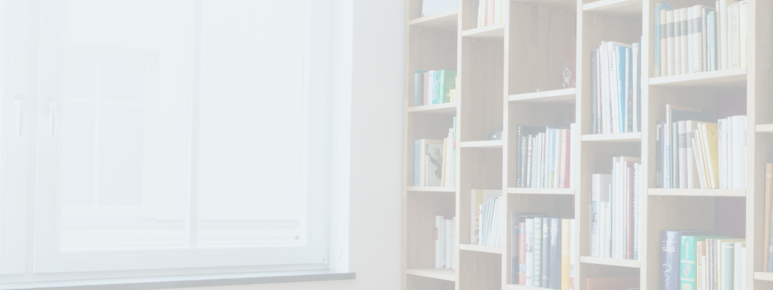 Books and various personal mementos neatly organized on a floor-to-ceiling shelving unit.