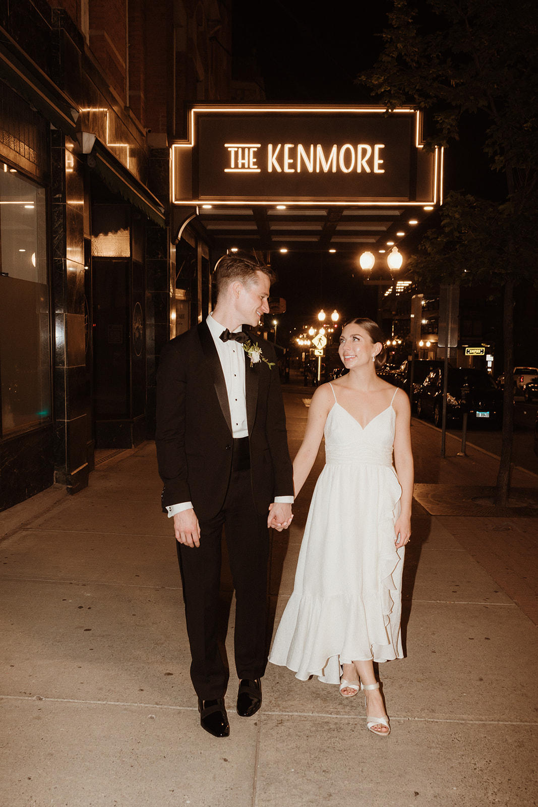 Couple standing outside of the Kenmore Ballroom at night