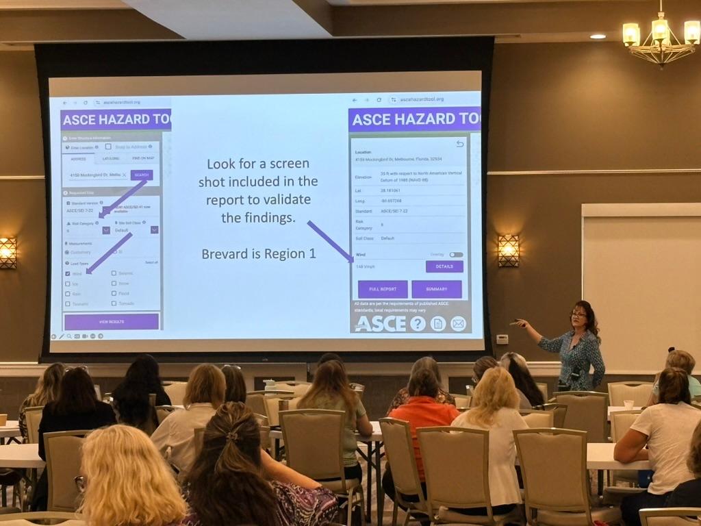 Presenter demonstrating wind mitigation report validation and hazard tool data in a home inspection  