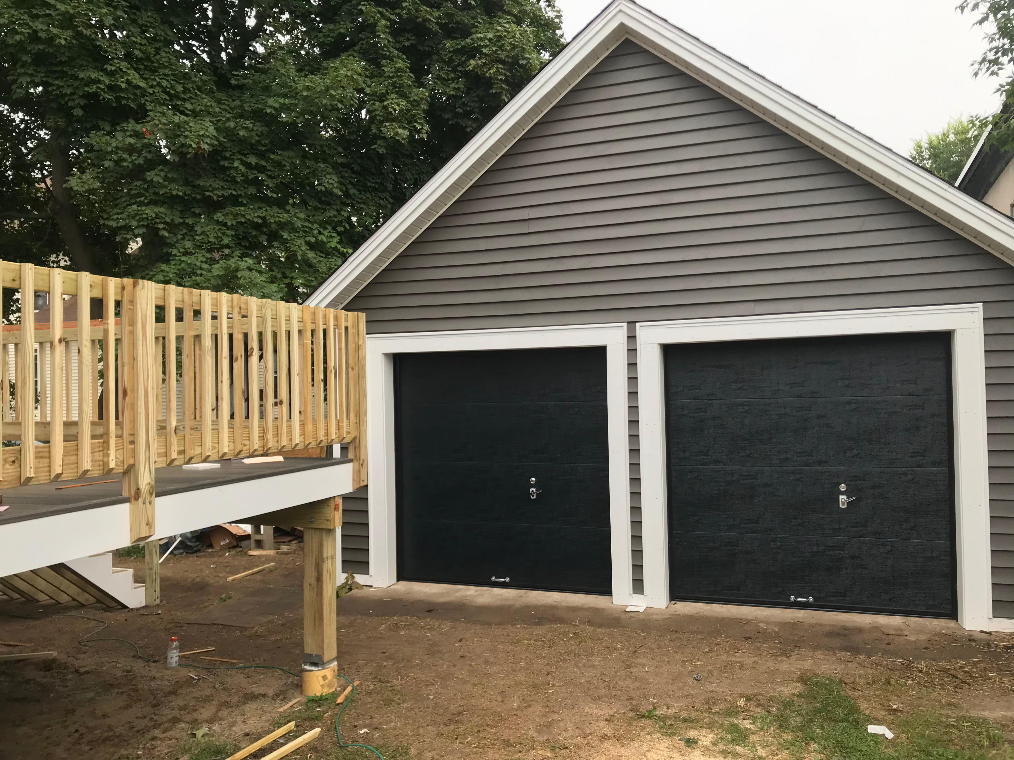 On this project in Concord, NH, we installed new siding, framing, and garage doors. We also built a new rear deck.