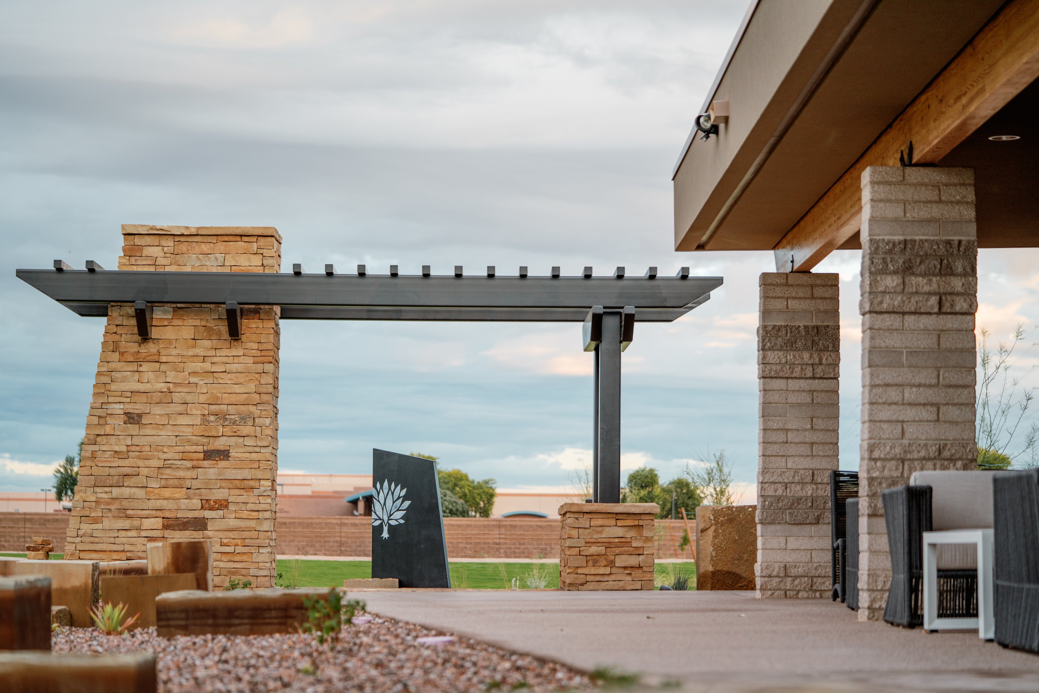 A stone pergola frames the view from the covered patio at Gilbert Memorial Park.