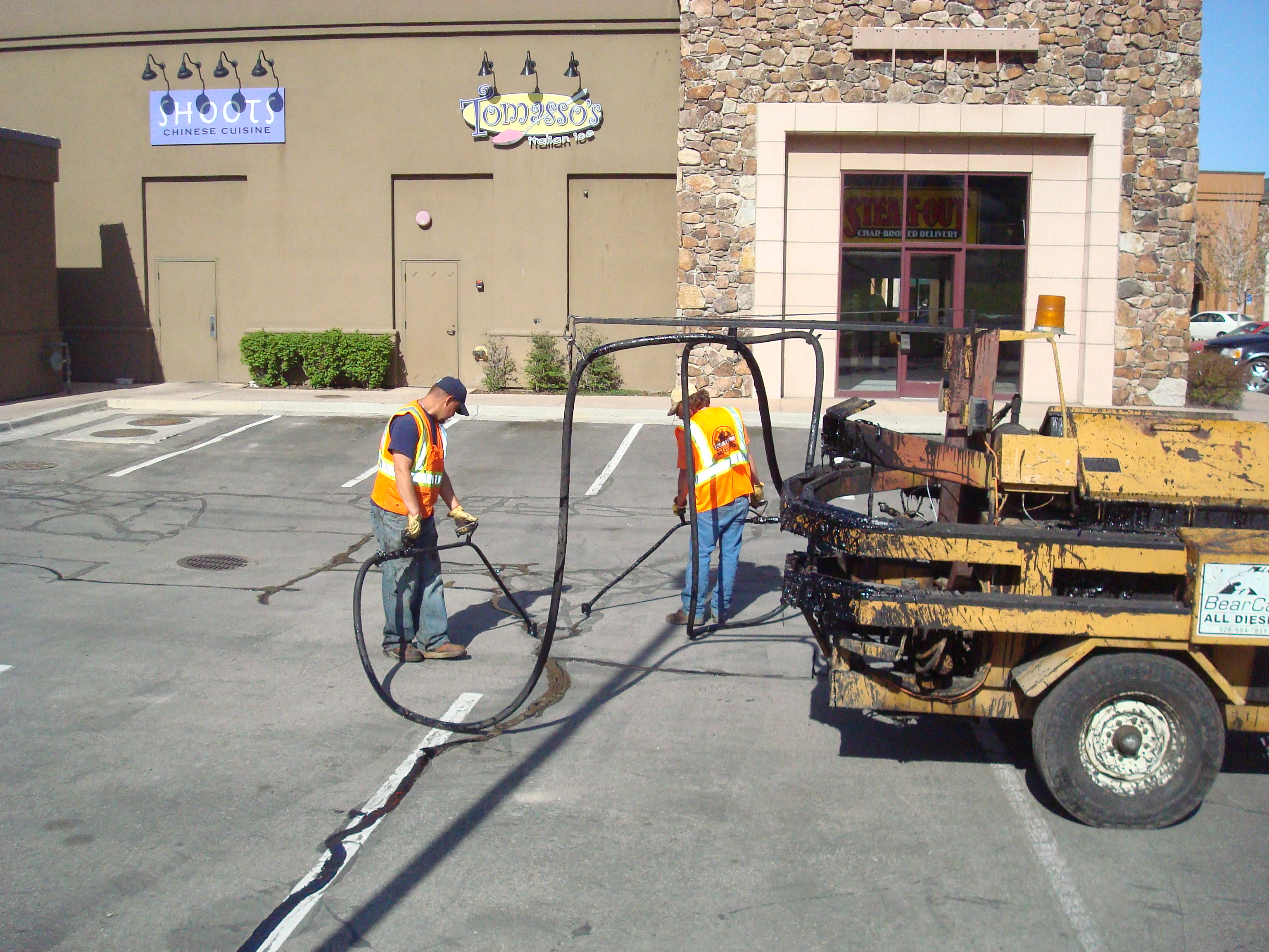 Eckles Paving crew applying professional sealcoating in Cache Valley Utah