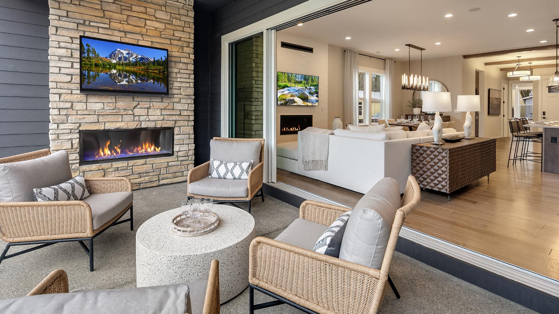 Covered patio with stacking glass doors offer seamless indoor-outdoor living