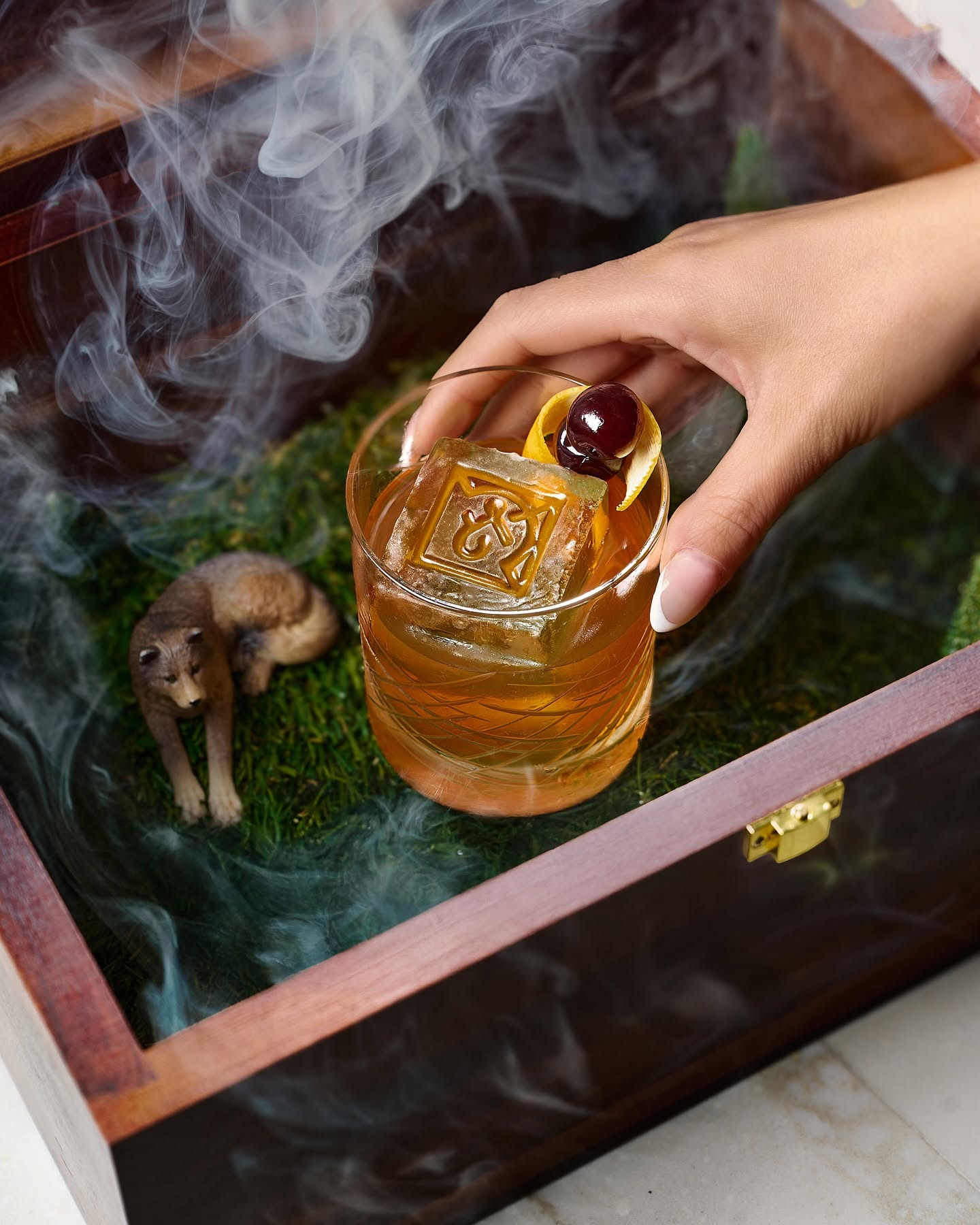 Crafted to impress &mdash; our signature smoked cocktail arrives in a cedar box with a touch of theater. Because your drink should be as unforgettable as your night.
