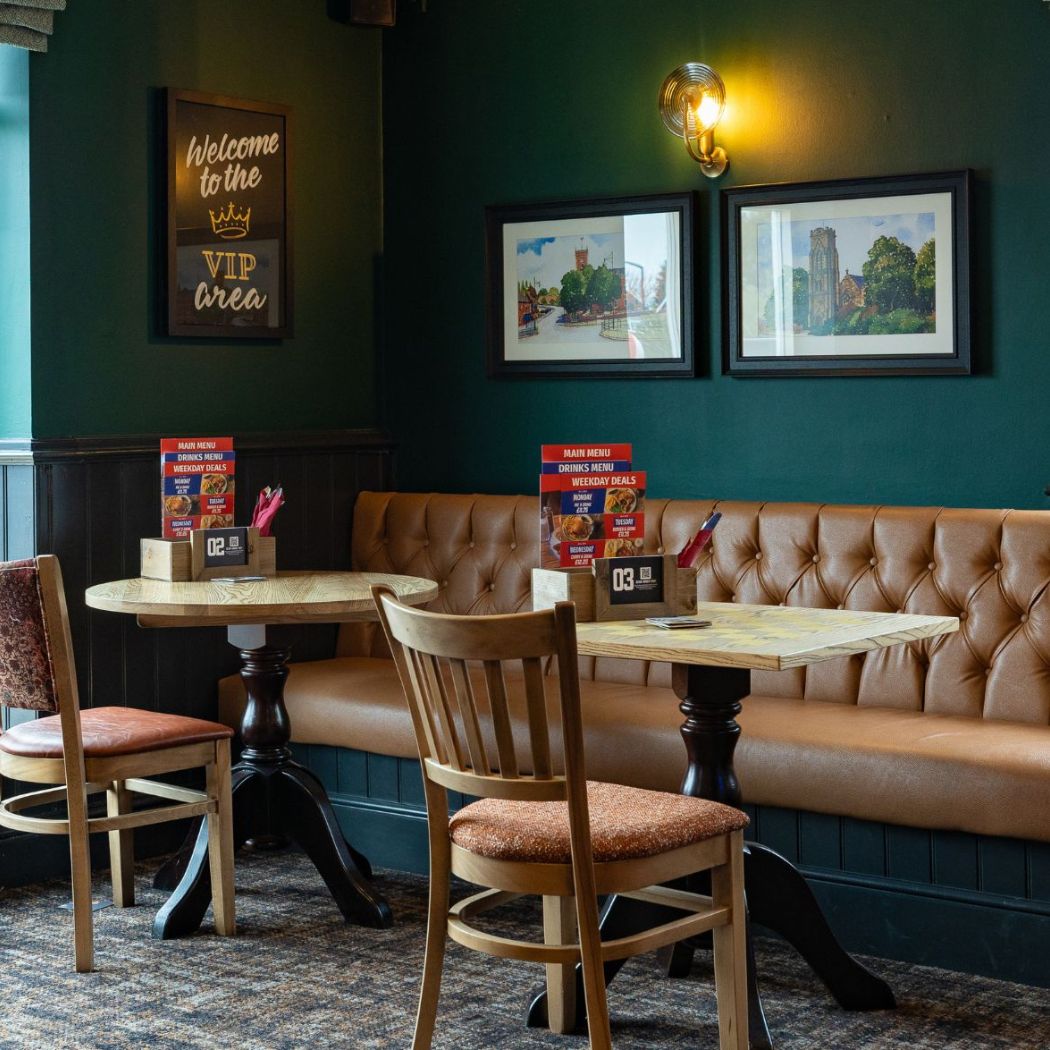 Comfortable booth-style seating in a dedicated eating area, ideal for small group gatherings and relaxed dining.