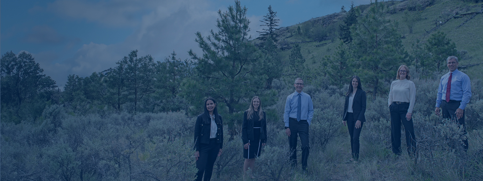 The Feistmann Wealth Management team, standing together on a hillside.