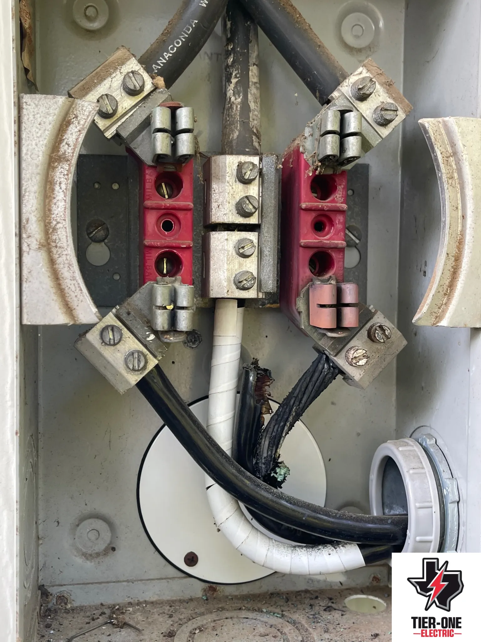 Electrical service equipment and wiring being inspected or serviced by Tier One Electric.