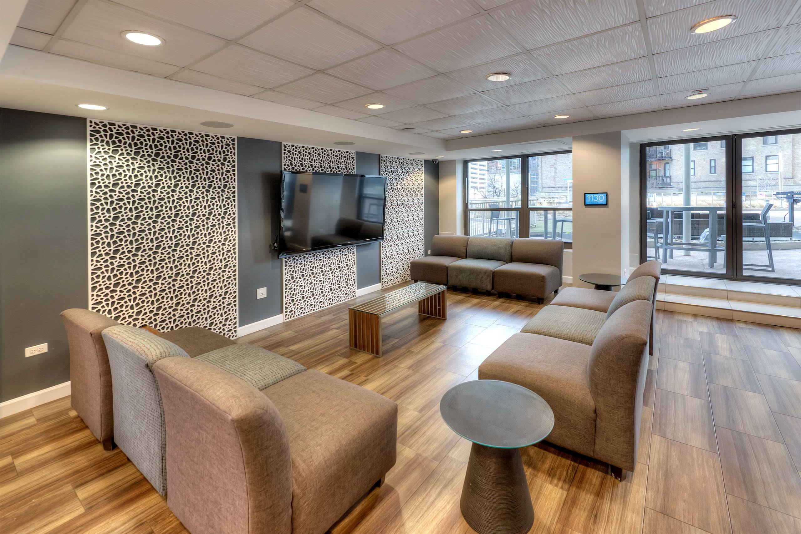 Resident lounge with decorative wall panels and comfortable seating 