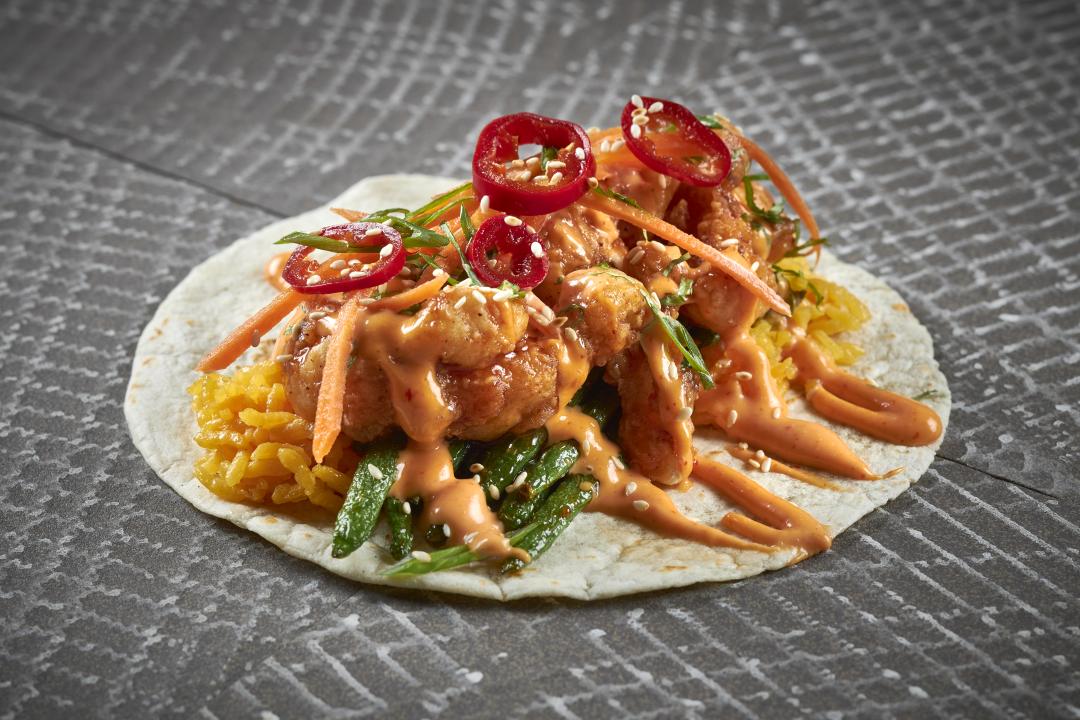 PF Chango taco nuestro with mexi sweet and sour chicken, blistered long beans, rice, pickled carrot, spicy aioli, toasted sesame, soy pickled chiles, flour tortilla, found at Taco Bamba's Fair Lakes location.