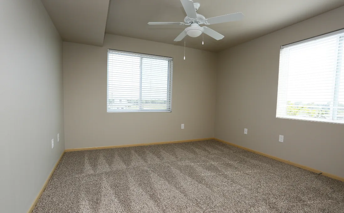 Room with windows and ceiling fan