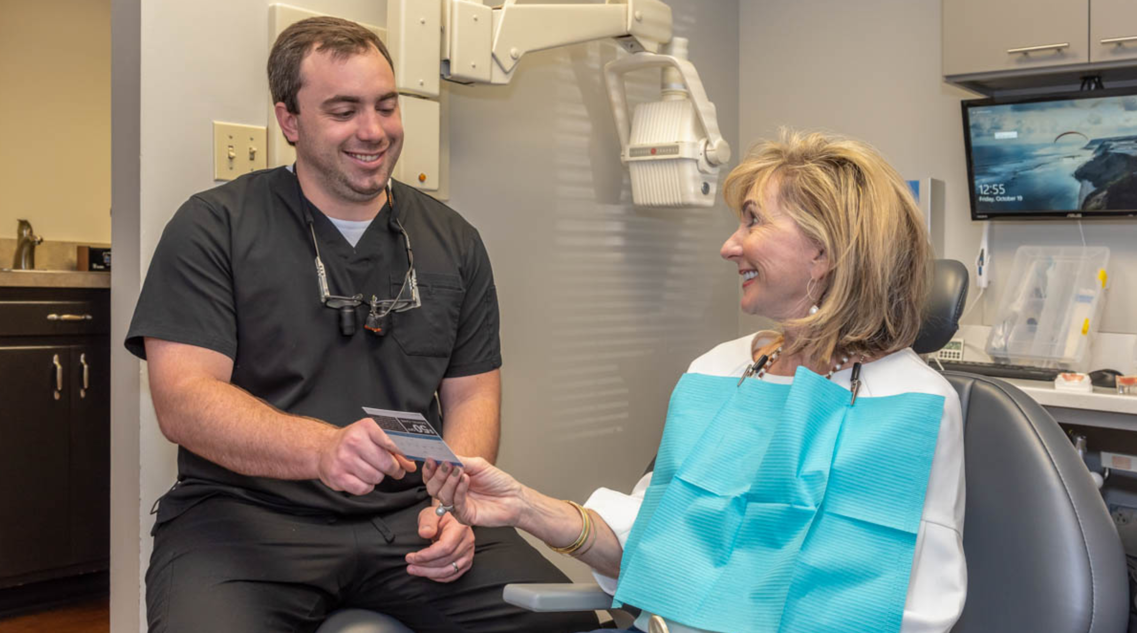 Dentist consulting with a patient at Hill Family Dental Columbia during a personalized dental visit.
