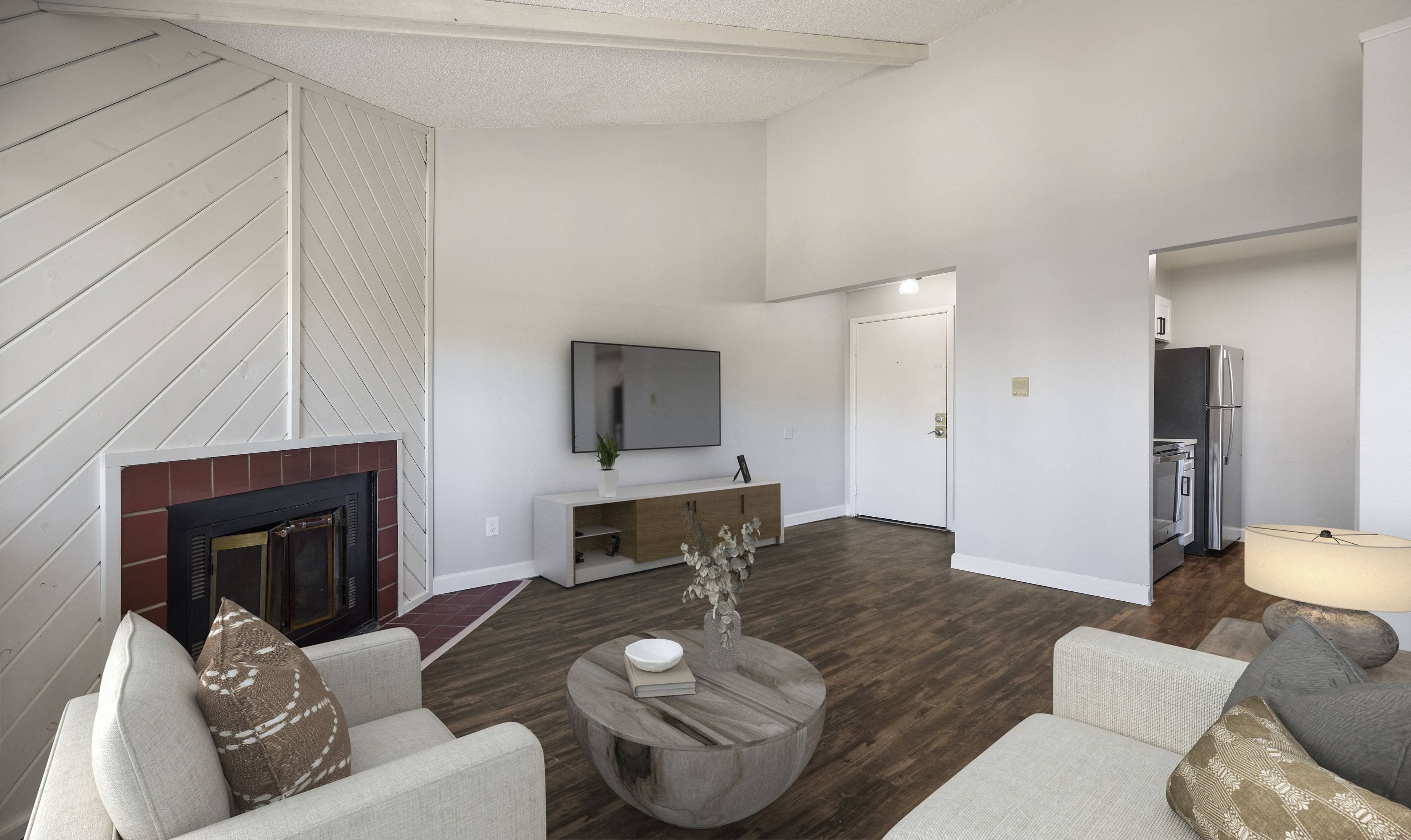 a living room with a fireplace and a tv 