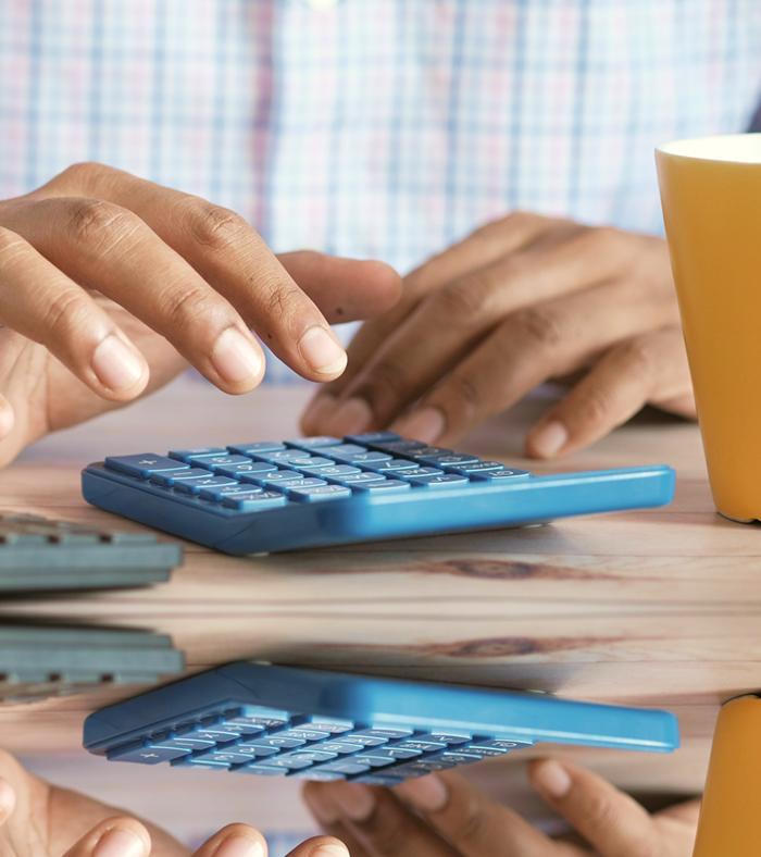 Person using a calculator at a desk.
