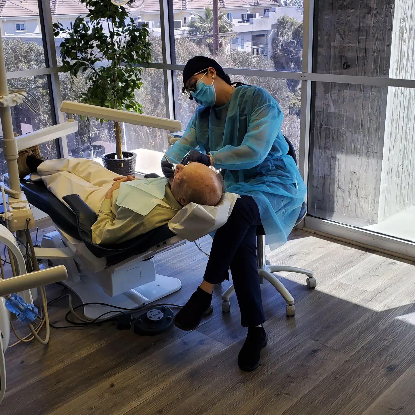 Doctor examining a patient at DNA Dental Studio