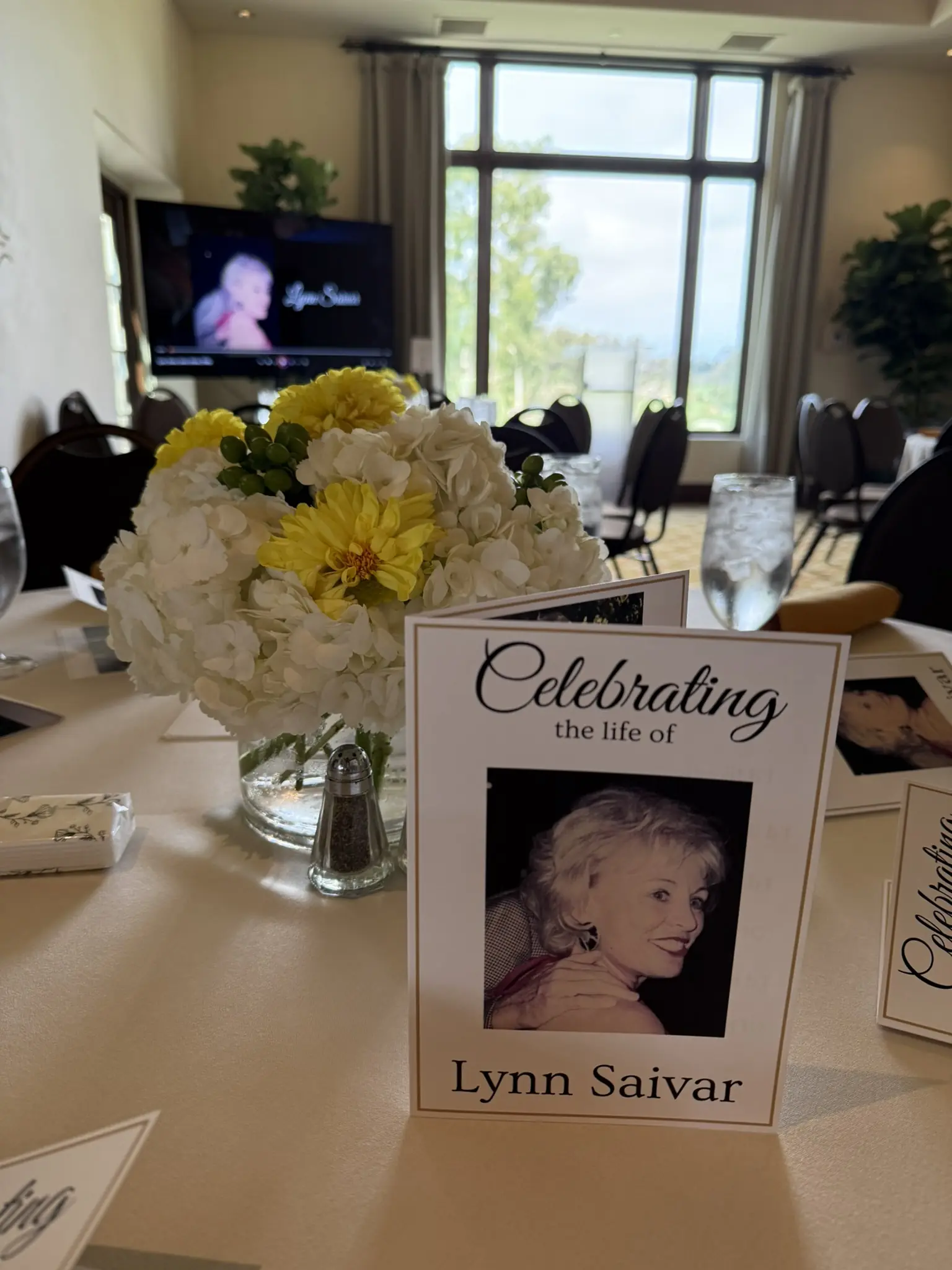 Modern indoor memorial service setup with personalized video tribute