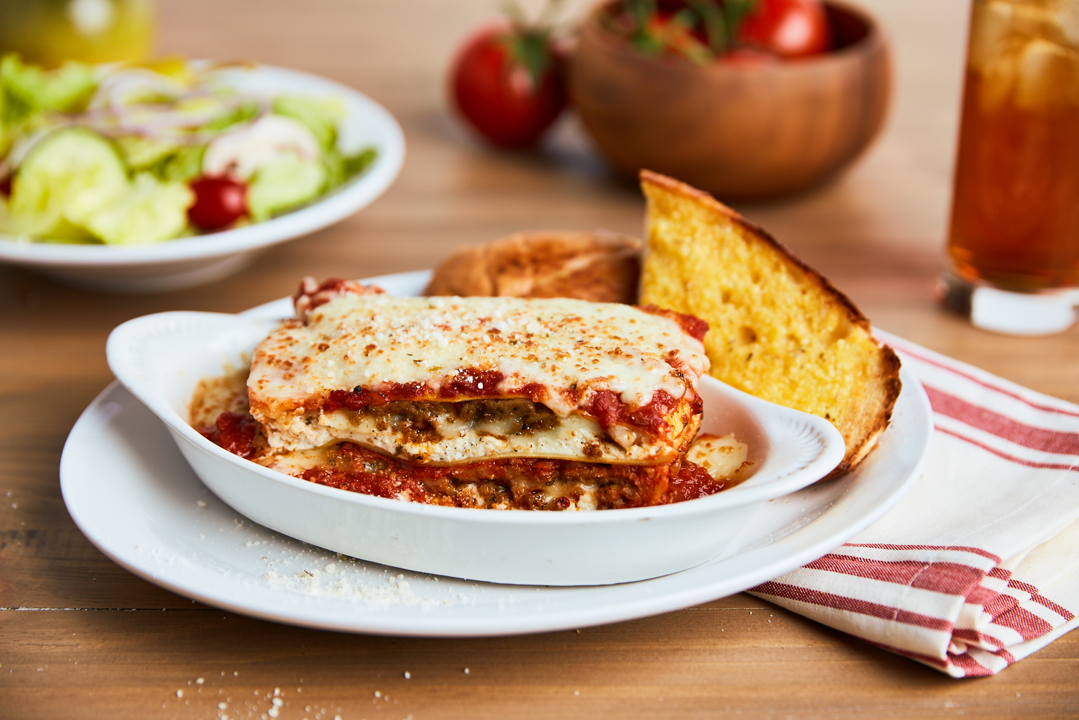 LASAGNA - Always a classic! Layers of seasoned ricotta, mozzarella, sliced meatballs & crumbled sausage baked in our marinara sauce.