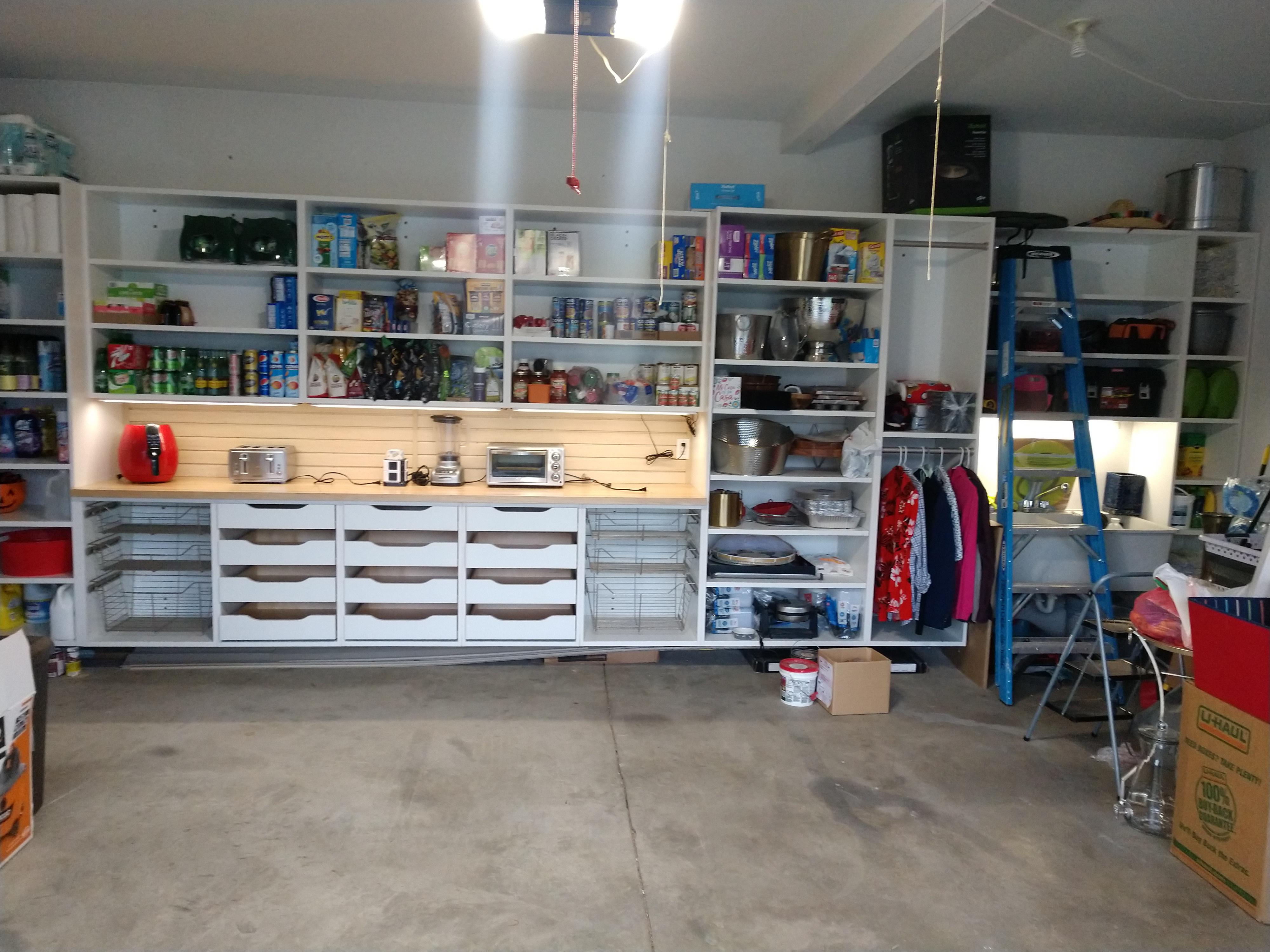 Custom pantry style garage cabinets with slat wall and under cabinet LED lighting in Harrisburg