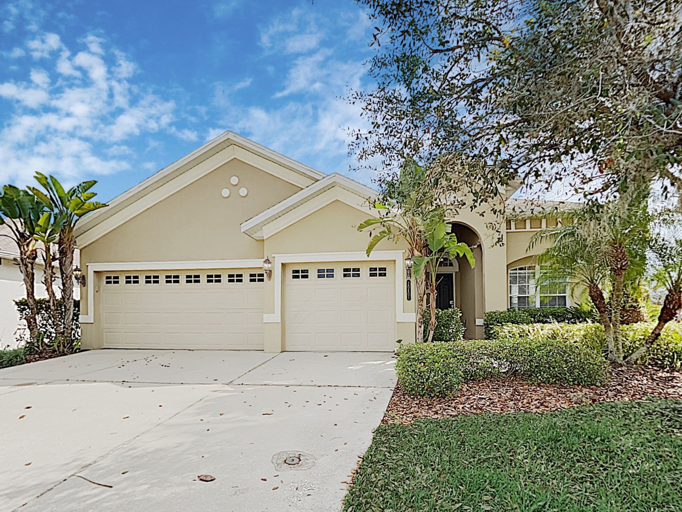 Front of home with three-car garage at Invitation Homes Tampa.