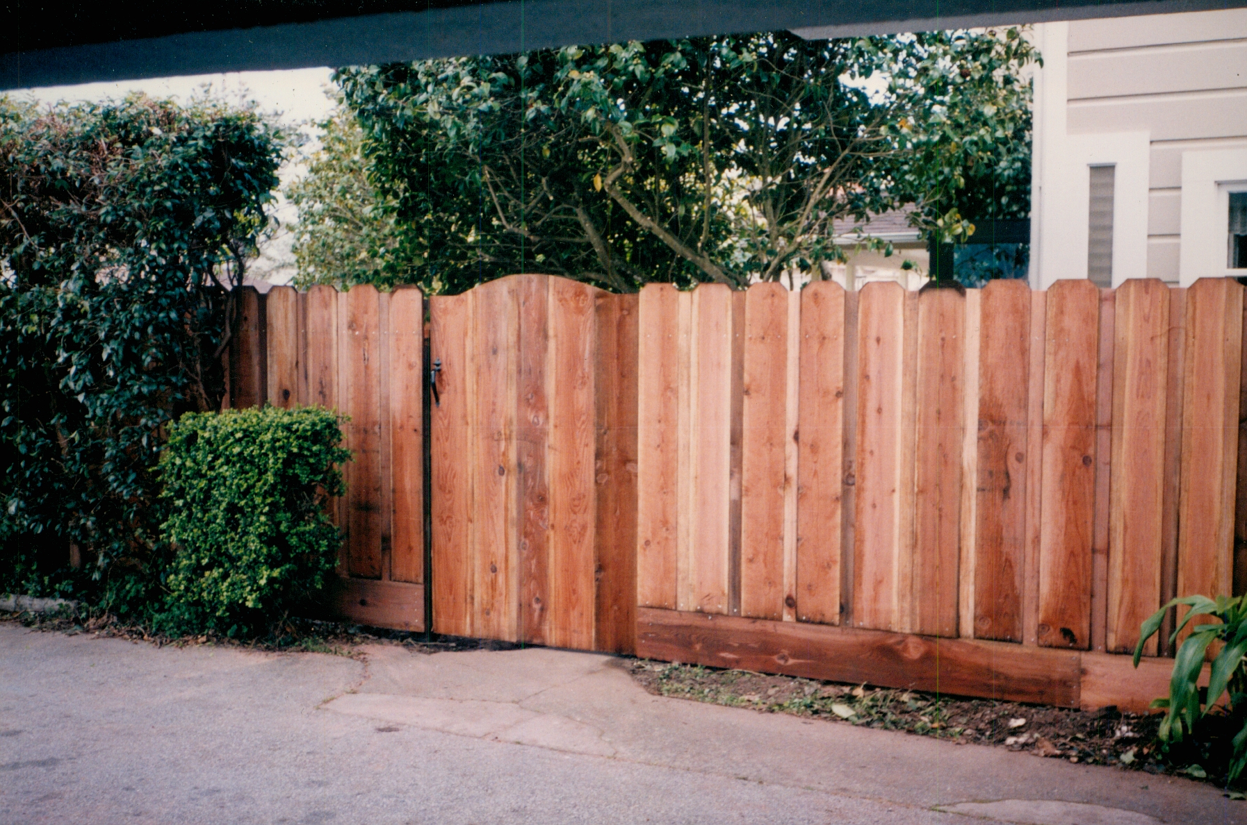 Residential wood fence and gate installation providing a secure boundary with natural curb appeal.