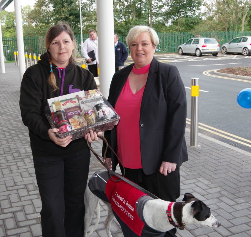 Greyhound Rescue organiser Tracy Cook receives a gift and £250 worth of B&M vouchers from store manager Julie Trainor.