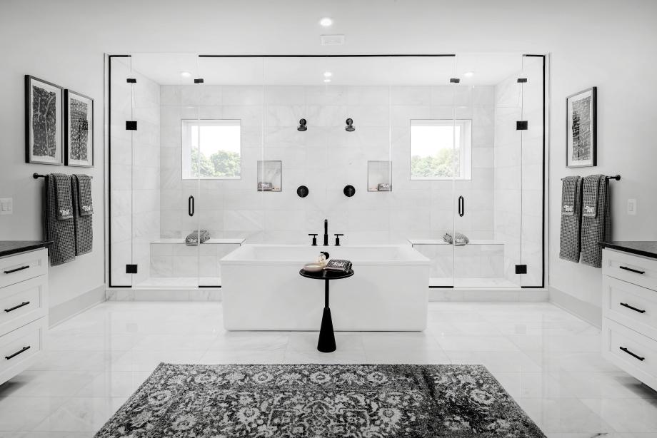 Lavish primary bath with dual vanities and free-standing tub