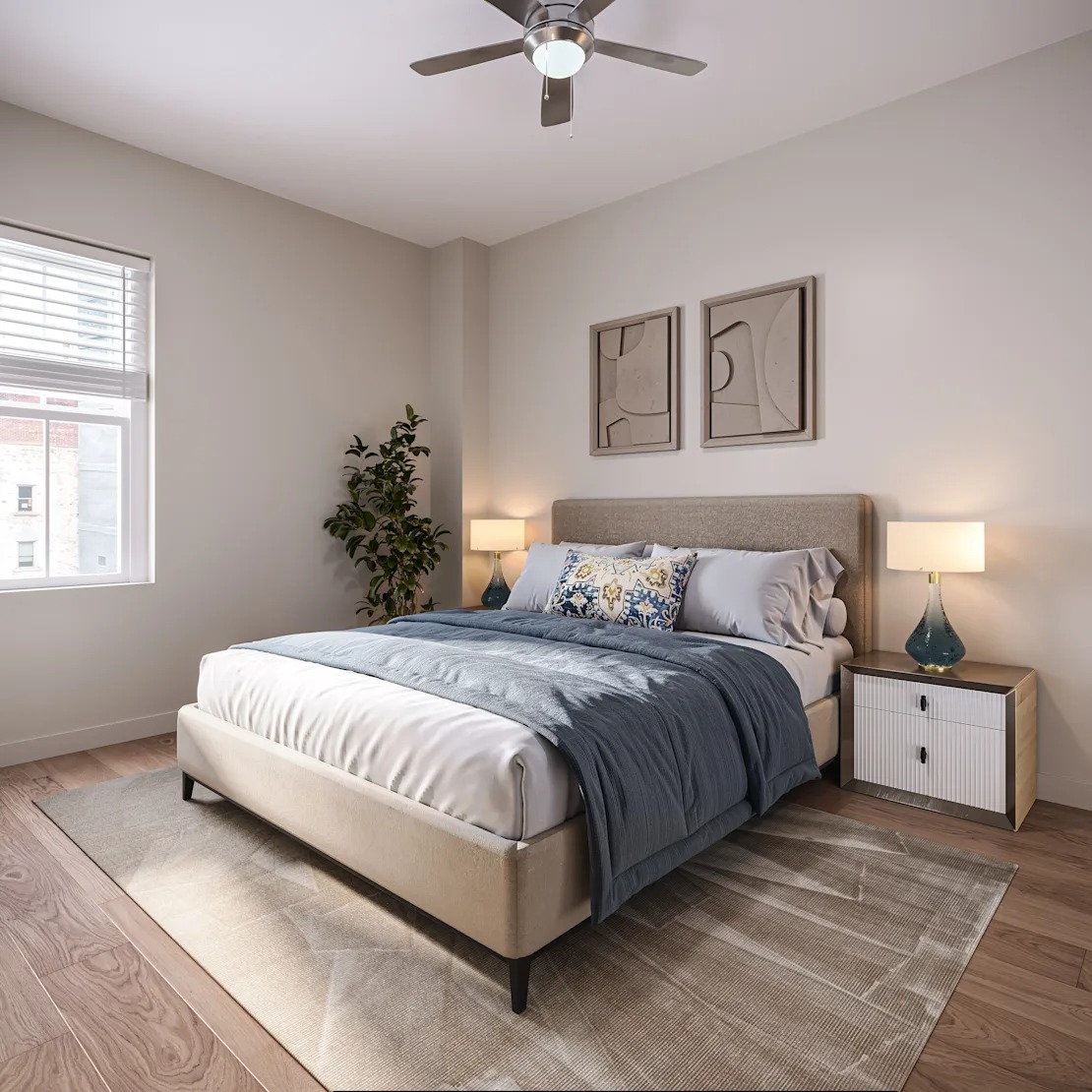A bedroom with a bed, nightstand, and a ceiling fan. 