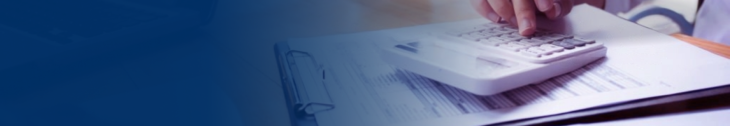 Close-up of a person punching numbers into a calculator.