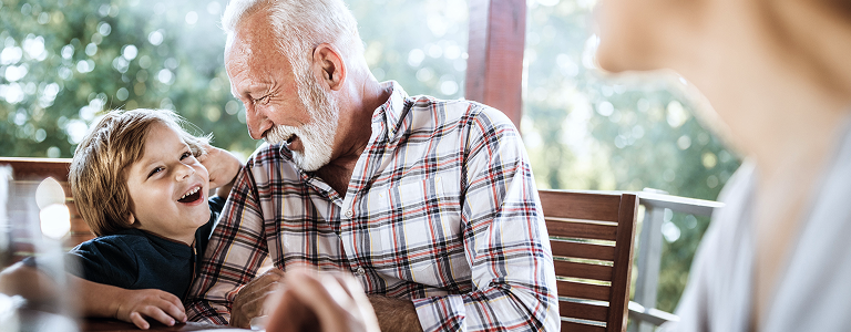 A grandfather sharing a laugh with his grandchild.