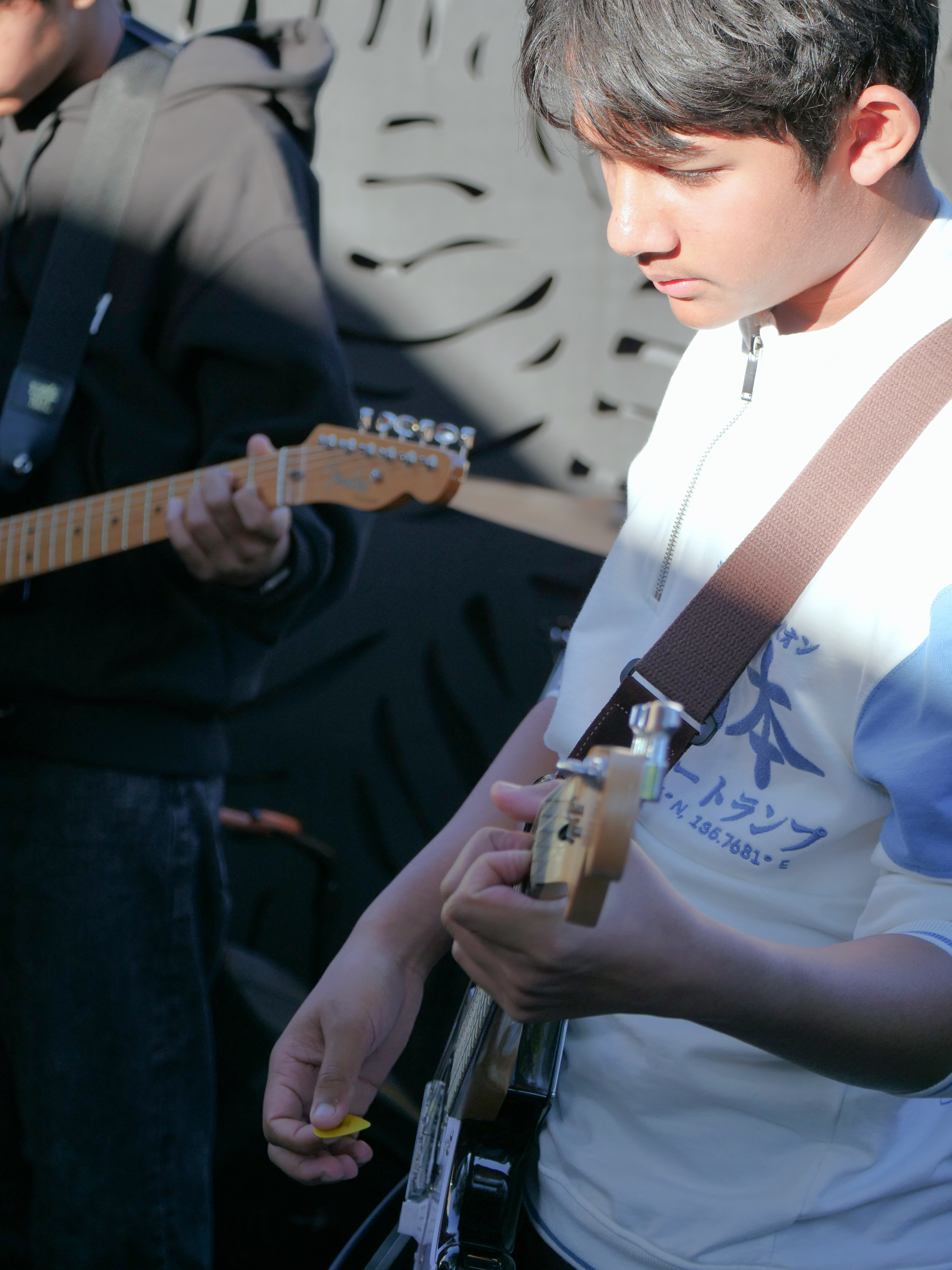 Young guitarist practicing in a student band setting as part of beNatural Music’s hands-on music education programs.
