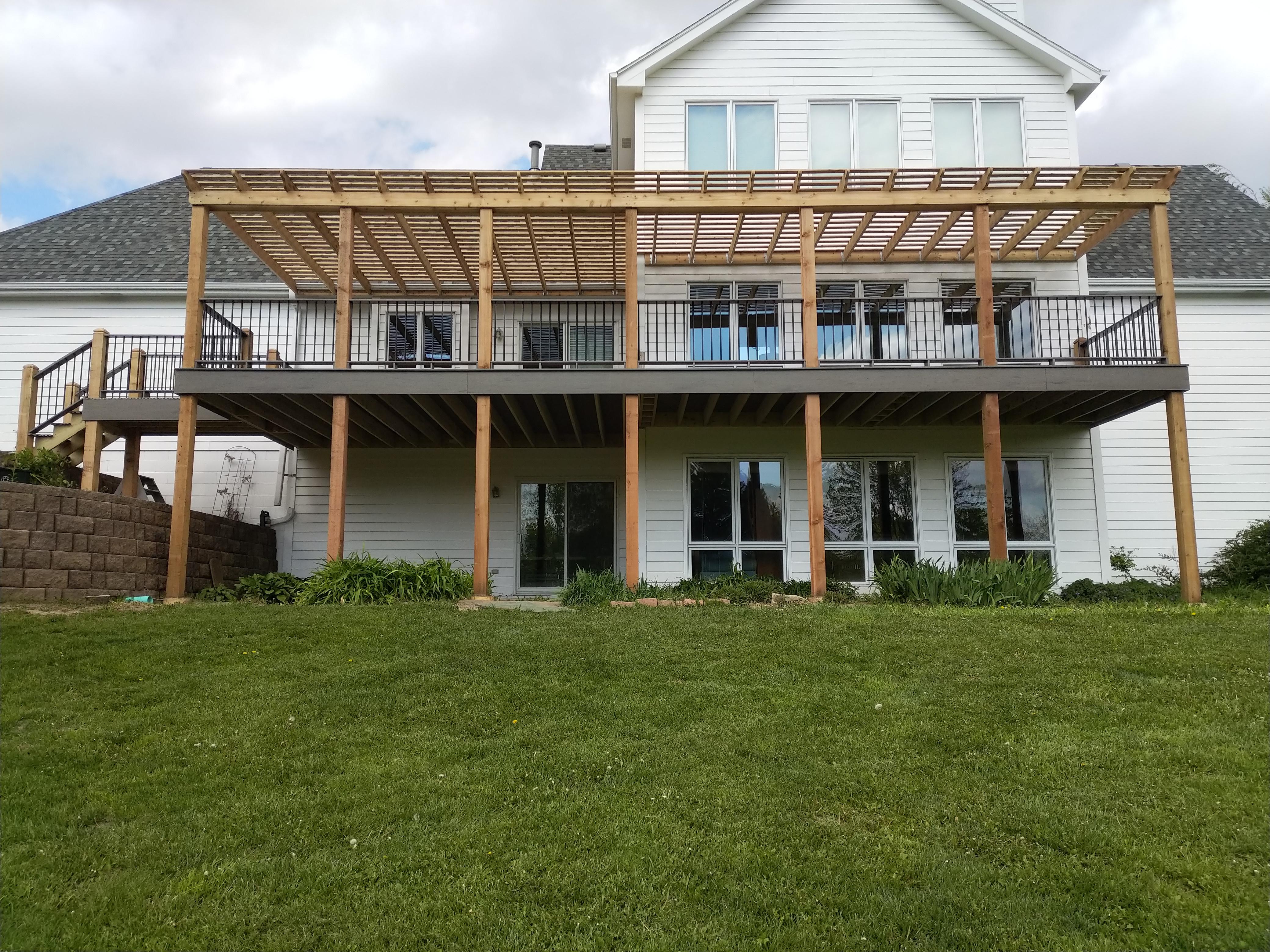 Timer Tech "Edge" Composite Deck with Composite Railing System with Black Alum. Spindles. Cedar Arbor with Aprox. 50% Shade Coverage.