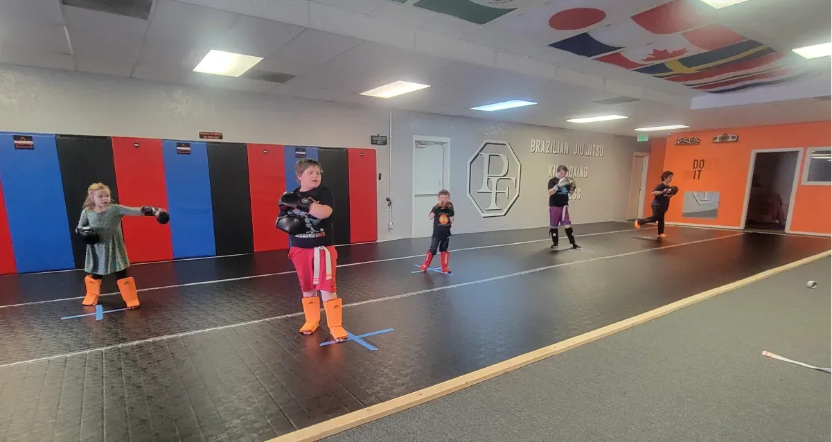 Youth martial arts class where kids build confidence, coordination, and discipline through fun, structured training that blends kickboxing and Jiu-Jitsu fundamentals in a safe, supportive environment.