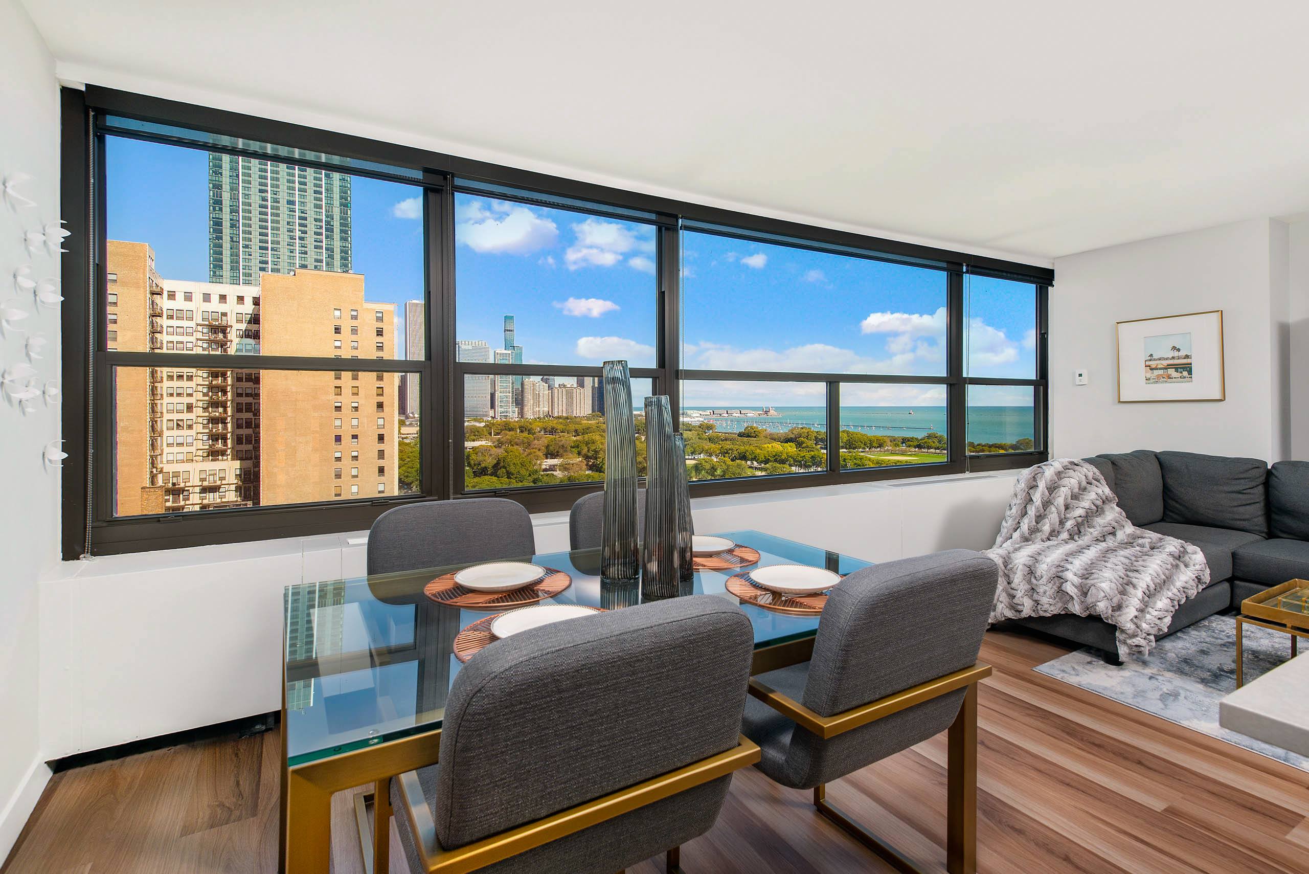 Dining area with glass table and lake views 