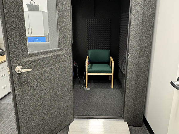 Interior photo of the sound proof hearing testing booth in the AudioNova hearing clinic in Batavia, IL