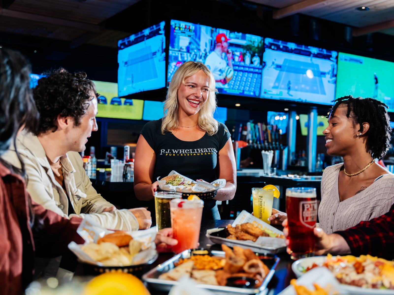PJ Whelihan's server, serving food to customers 