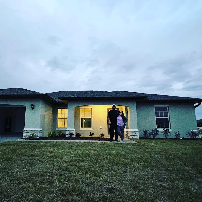 Happy Customers Celebrating Outside Their South Florida Home After Closing with 1st Florida Mortgage 