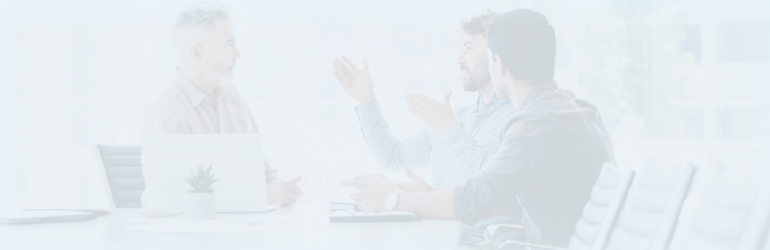 Three people having a meeting in a boardroom.