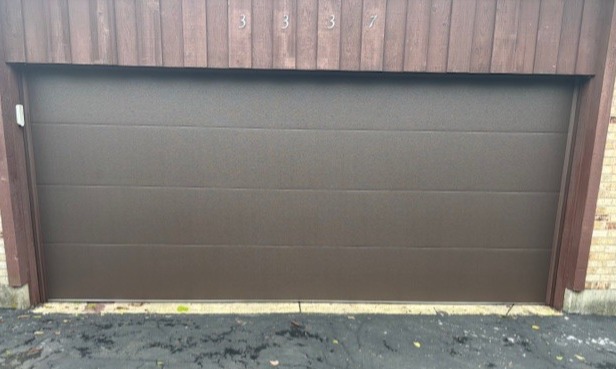 Flush-panel residential garage door installed by Highfield Door Sales in Kettering, Ohio