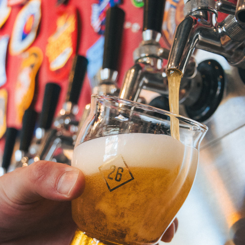 A fresh pint is poured from the tap wall at Station 26 Brewing Co., showcasing the brewery's rotatin 