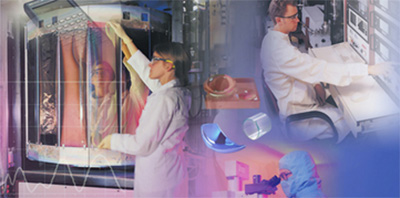 Quality control technicians in cleanroom environment inspecting optical components using specialized equipment. Rigorous testing ensures coatings meet military specifications (MIL-C-48497, MIL-F-48616, MIL-M-13508) and space qualification standards. Environmental testing includes humidity, salt fog, abrasion resistance, temperature cycling, and thermal shock validation.