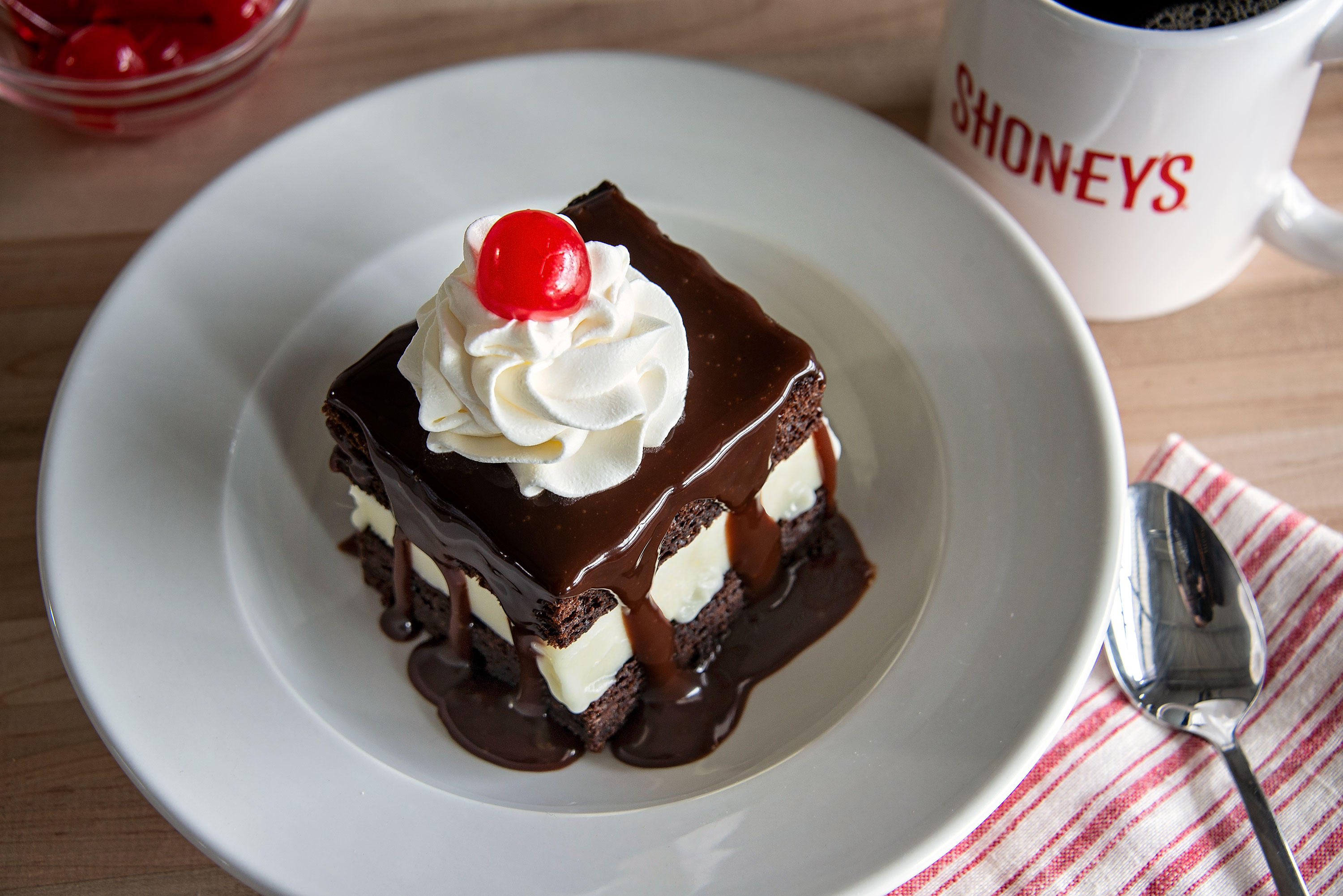 Our world famous Hot Fudge Cake! Vanilla ice cream between freshly baked layers of Shoney's® famous chocolate cake, covered in hot fudge sauce, whipped topping, and a cherry.