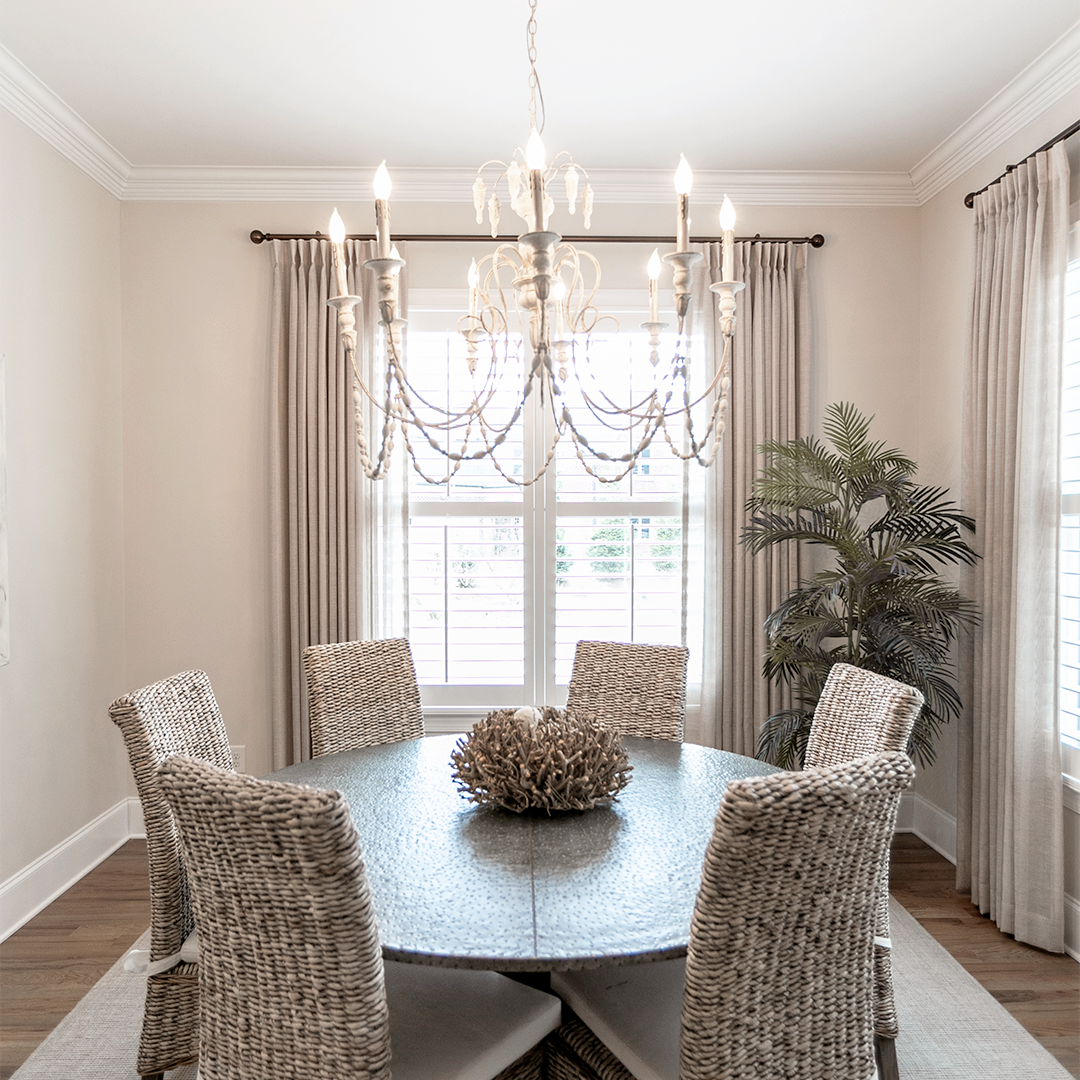 A mixture of shutters and drapery forms a cohesive look in this stunning dining room. Enjoy the functional benefits of your window coverings while maintaining your interior design style!