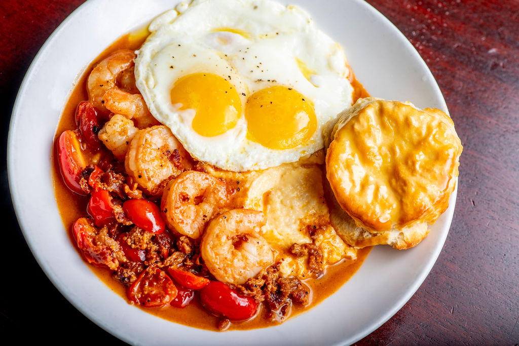 Blackened Shrimp Grits: cheese grits, bacon, saut&eacute;ed tomatoes, over-easy egg, biscuit