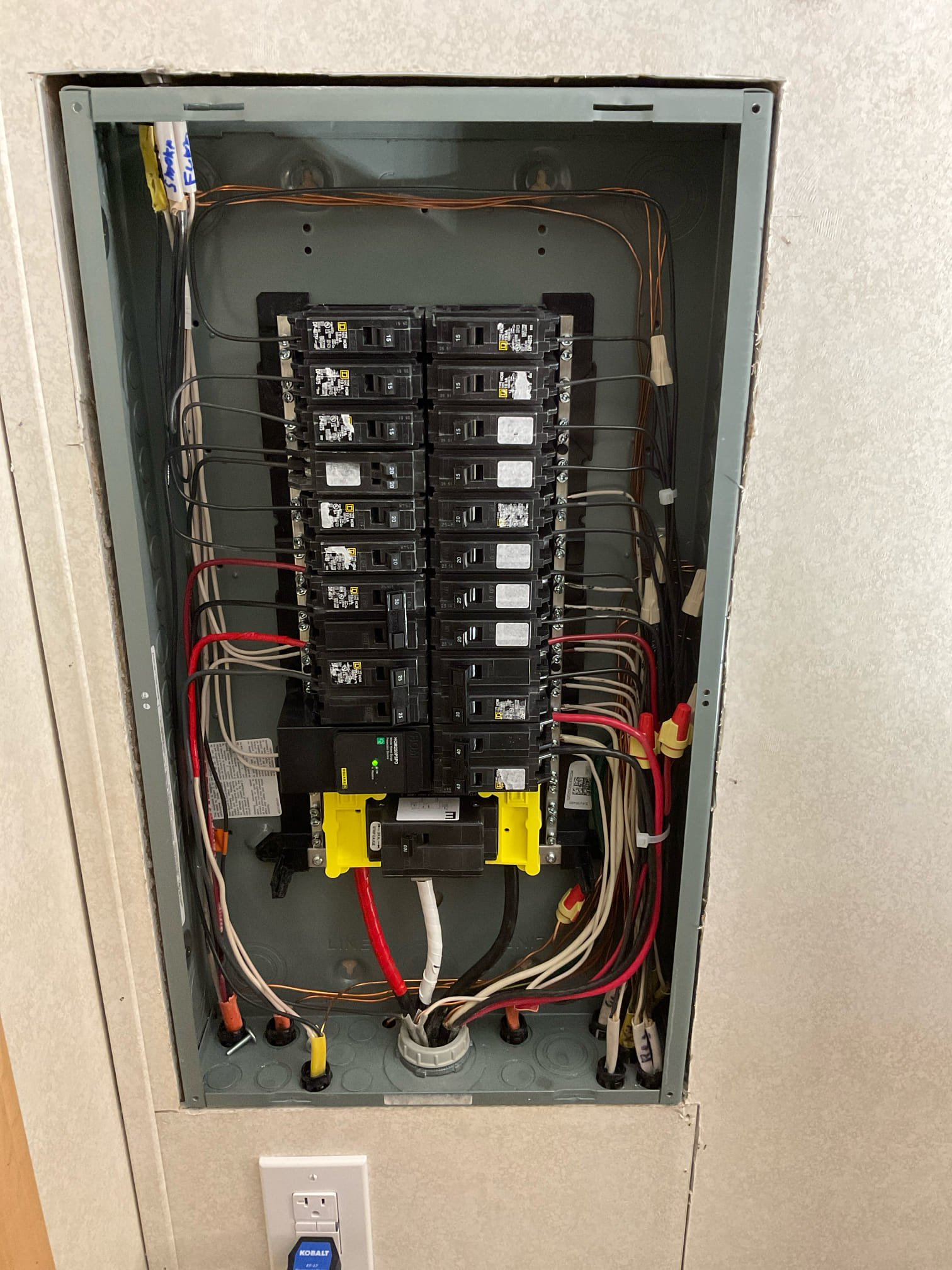 Thomas Edison Electric upgraded this Square D breaker panel in a Lebanon, PA home. The panel is fully loaded with Square D breakers, including a QO main breaker with yellow handle tie at the bottom, and a dedicated outlet is installed directly below for convenient access.