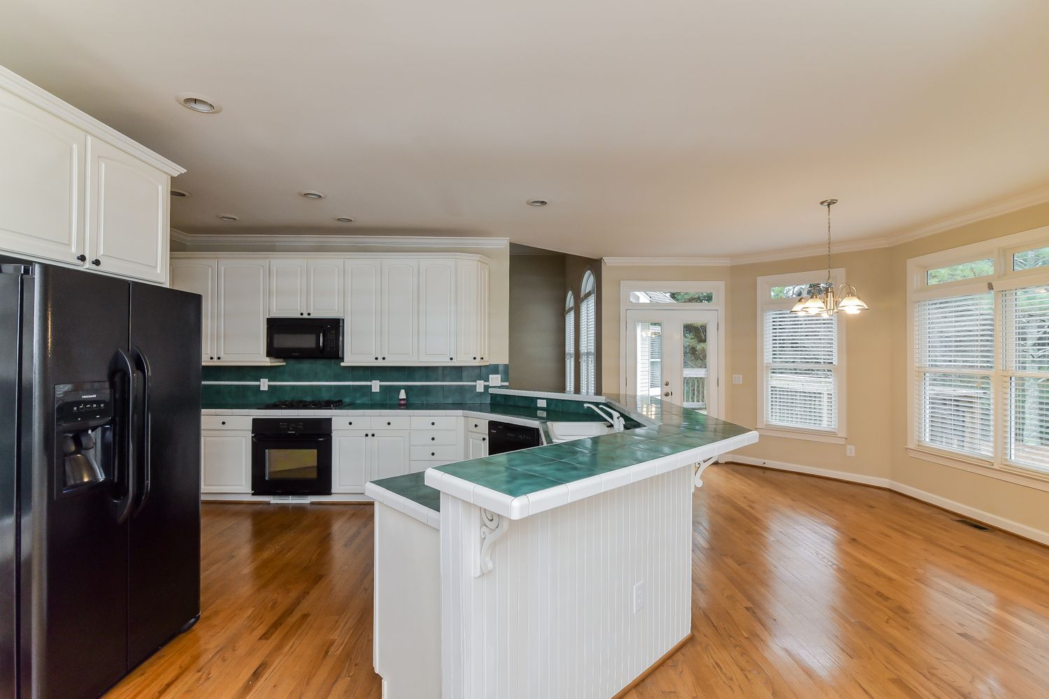 Bright kitchen with wood flooring at Invitation Homes Atlanta.