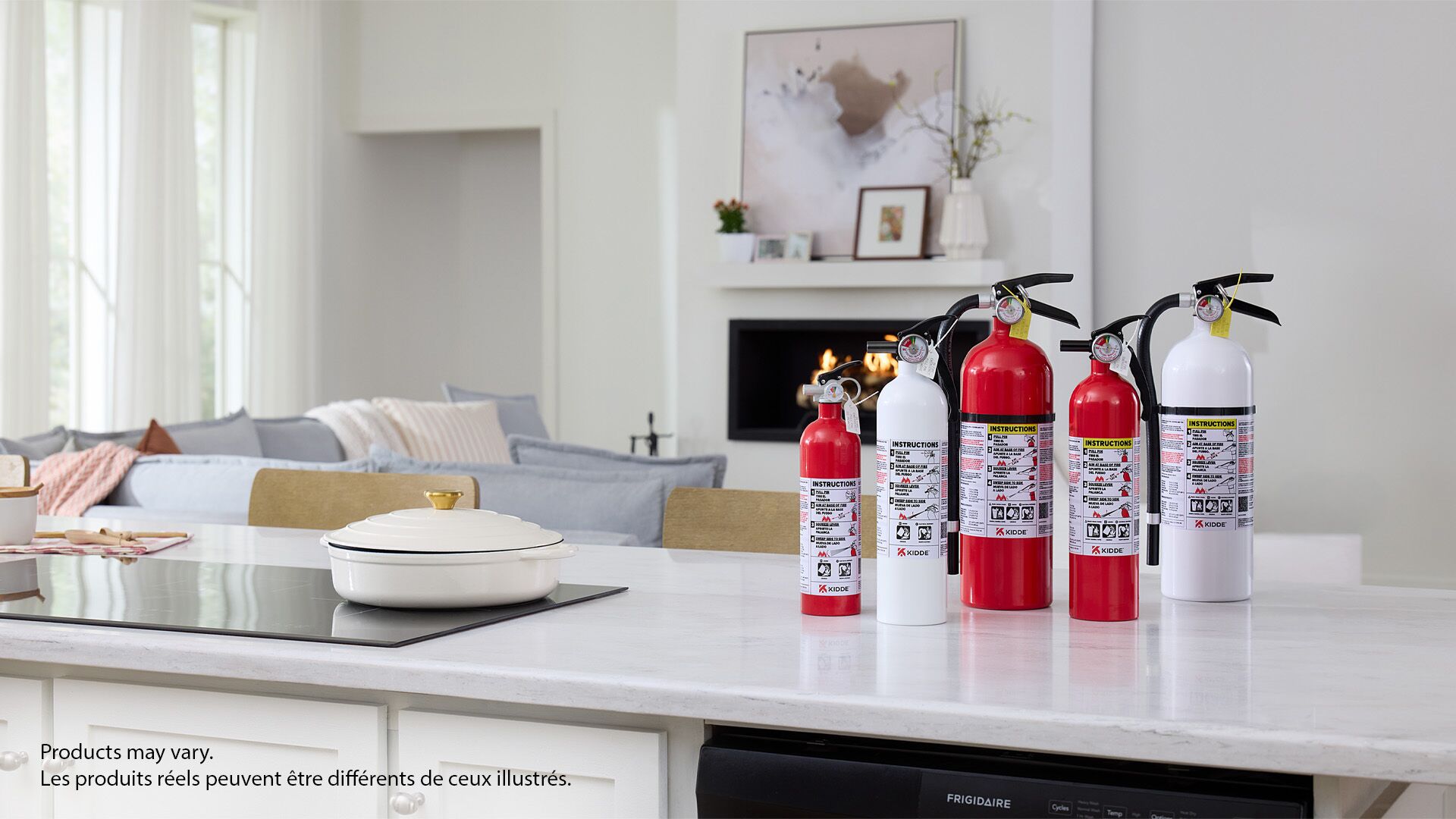 A group of Kidde fire extinguishers on a counter.