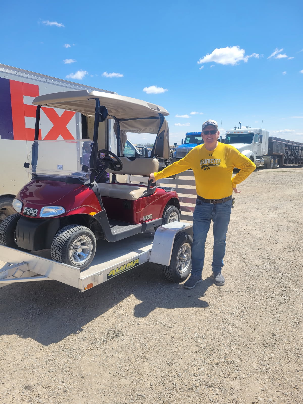 Customer from Kanawha Iowa with 2013 EZGO Freedom RXV electric golf cart after new battery installation at Miller & Sons Golf Cars in Britt IA. Golf cart service including battery replacement available across North Iowa.